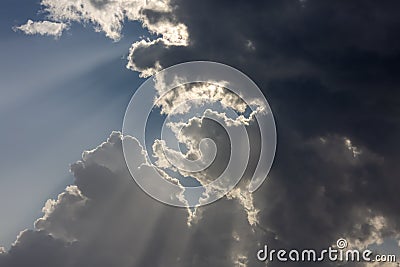 Dramatic Sky and Sun Rays Background. Sunbeams Light and Moody Cloudscape Stock Photo