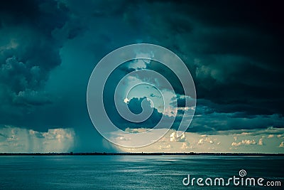 Dramatic storm clouds over the lake. Tropical cyclone, Clouds rain and big storms with rain on the reservoir Stock Photo