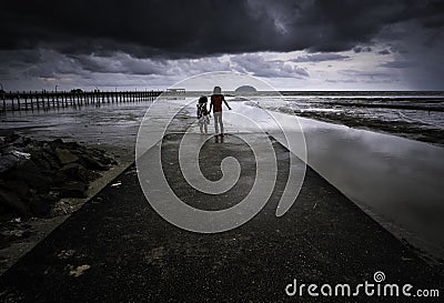 Dramatic stormy clouds at a beach Editorial Stock Photo