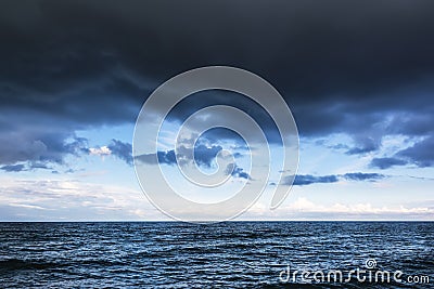 Dramatic stormy sky with dark clouds over the sea Stock Photo