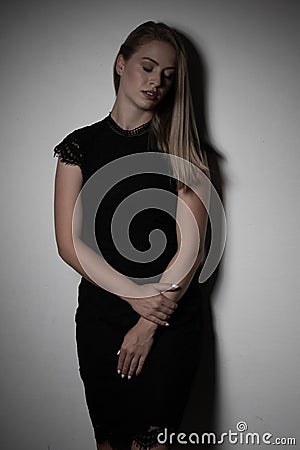 Dramatic studio portrait of beautiful young woman on dark background Stock Photo