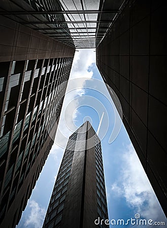 The dramatic stunning Alpha tower block building looking up at the sky jumbo jet aeroplane trail over commercial sector cityscape Editorial Stock Photo