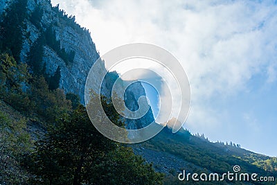 Dramatic sun shining through clouds mountain Stock Photo