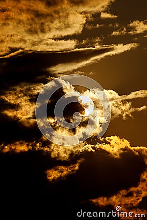 Dramatic sunset with clouds. The round sun sits down Stock Photo