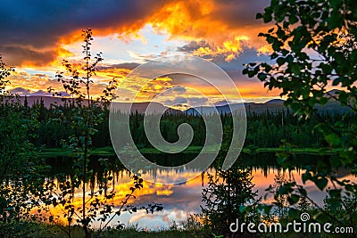 Dramatic sunset in the mountains. The light of the fading day, like a fire in the woods Stock Photo