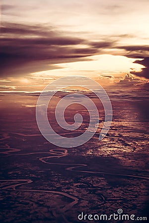 Dramatic sunset over the earth from the height in vintage style with epic sky. Stock Photo