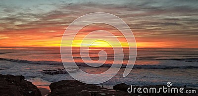 Dramatic Sunset over Pacific Ocean - Waves Crashing on the Rocks Stock Photo