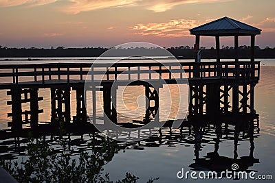 Dramatic sunset sunrise reflecting on the water in Ormond Beach, Florida Stock Photo