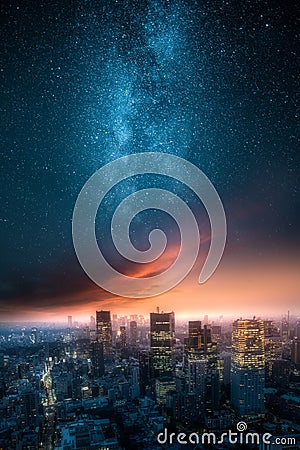 Dramatic view of a city skyline at night with milky way Stock Photo