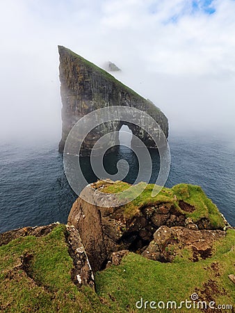 Drangarnir Rocks during mist and fog in the Faroe Islands, Denmark Stock Photo