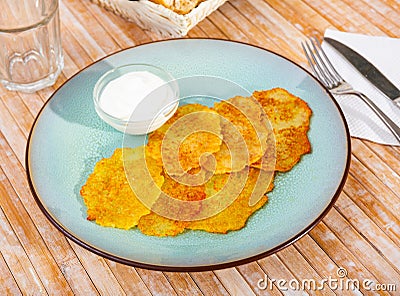 Draniki with sour cream at plate, dish of Belarusian cuisine Stock Photo