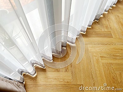 Draped curtains hanging on window in home Stock Photo