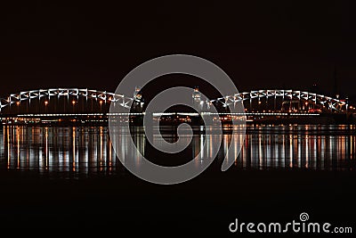 Drawbridge in St. Petersburg, illuminated by lights and reflected in the river Neva Stock Photo