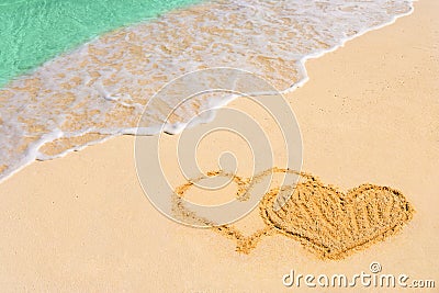 Drawing connected hearts on beach Stock Photo