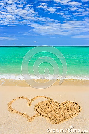 Drawing connected hearts on beach Stock Photo