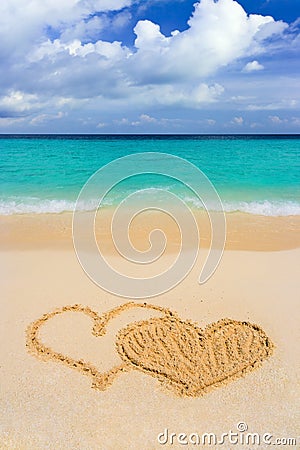 Drawing connected hearts on beach Stock Photo