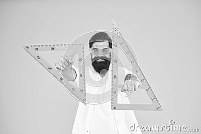 For drawing, draughting and design. Hipster holding drawing instruments on yellow background. Architect and engineer Stock Photo