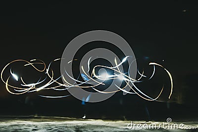 Drawing light in the dark. Round scribbles at night. How to shoot freezelight. Unusual frame in the night Stock Photo