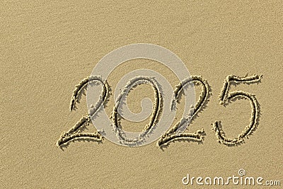 Drawing sun and 2025 on the sandy beach of the coastline as a symbol of the beach season Stock Photo