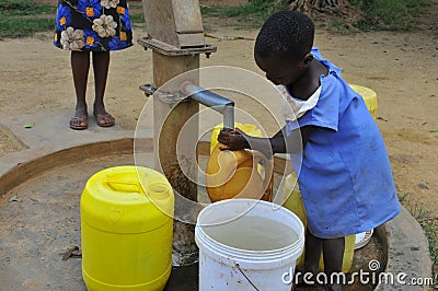 Drawing water from the bore hole Editorial Stock Photo