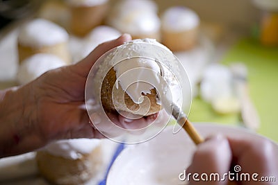 Drawing white sweet cream on top of the baking pastries Stock Photo