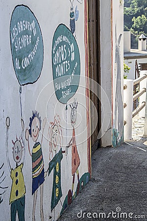 drawings on the facade of a school of smiling children with balloons Editorial Stock Photo