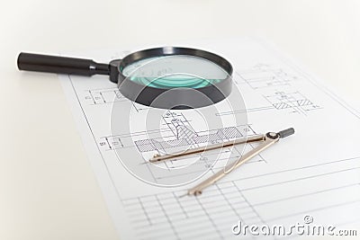 Drawings, magnifier and compasses Stock Photo