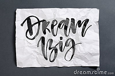 Dream big. Handwritten text on white crumpled paper. Inspiration Stock Photo