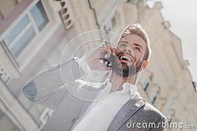 Dream bigger. Do bigger. Young businessman talking on smartphone. Casual urban professional businessman using mobile Stock Photo