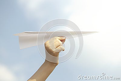 Dream concept of a person flying a paper plane in the sky Stock Photo