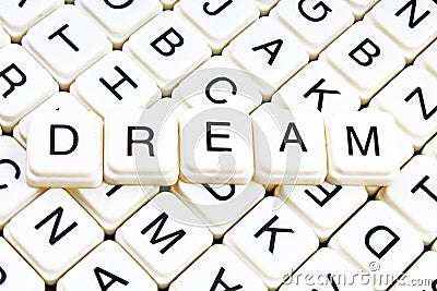 Dream text word crossword title caption label cover background. Alphabet letter toy blocks. White alphabetical letters. Stock Photo