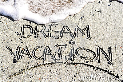Dream vacation phrase handwritten on the beach Stock Photo