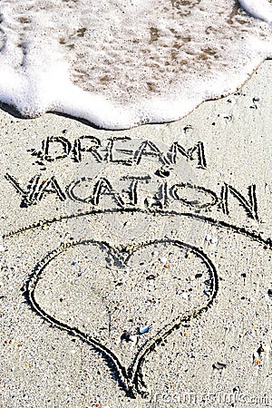 Dream vacation phrase handwritten on the sandy beach Stock Photo