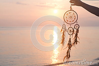 Dreamcatcher, on sunrise sea background, magical indian shaman Stock Photo