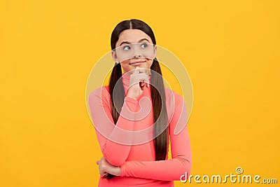 dreaming child with long hair on yellow background, daydreamer Stock Photo