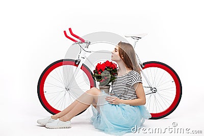 Dreaming girl with flowers and bike Stock Photo