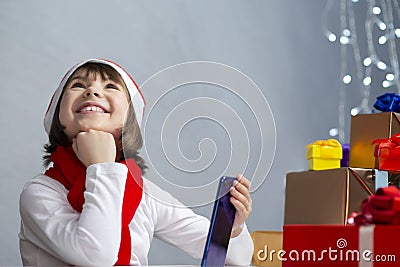 Dreaming Happy Smiling Caucasian Girl Wearing Santa Hat Using Laptop for Online Video Virtual Classroom on Digital Laptop Device Stock Photo