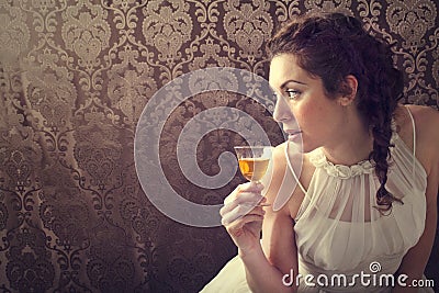 Dreaming woman drinks a glass of excellent Scotch whisky Stock Photo