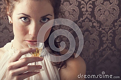 Dreaming woman drinks a glass of excellent Scotch whisky Stock Photo