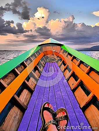 Dreamlike image of female feet in a rowing boat on Inle Lake, Myanmar Stock Photo