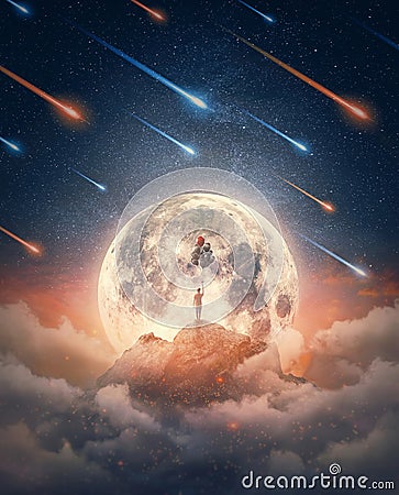 Dreamlike nightscape and a lone man celebrating with balloons in front of the full moon rising above the mountain peak. Stock Photo