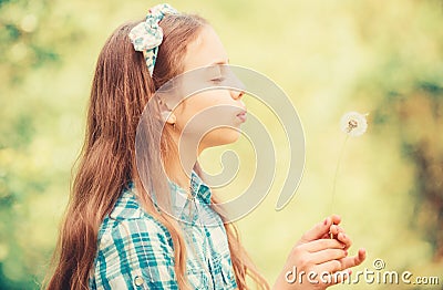 Dreams come true. Dandelion full symbolism. Summertime fun. Beliefs about dandelion. Girl making wish and blowing Stock Photo