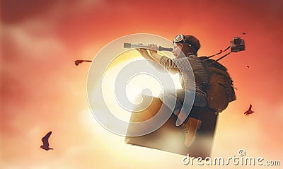 Child flying on a suitcase Stock Photo