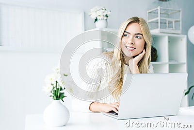 dreamy blonde businesswoman working with laptop Stock Photo