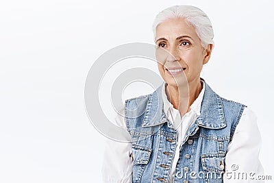 Dreamy, carefree happy smiling old woman dreaming about meeting grandkids during christmas family reunion, grinning Stock Photo