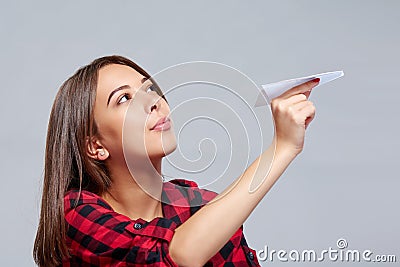 Dreamy female holding white paper plane Stock Photo