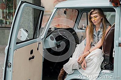 Dreamy hippie woman driving a classic camper van Stock Photo