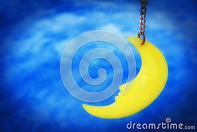 Dreamy moon hanging on string with night sky background. Stock Photo