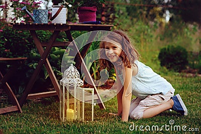 Dreamy romantic kid girl relaxing in evening summer garden Stock Photo