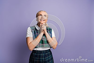 Dreamy student with clenched hands looking Stock Photo